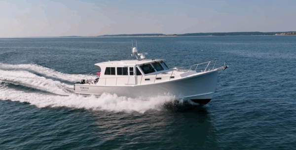 Starboard bow view of a 2016 Wesmac 42 cruising, with ocean and sky visible.