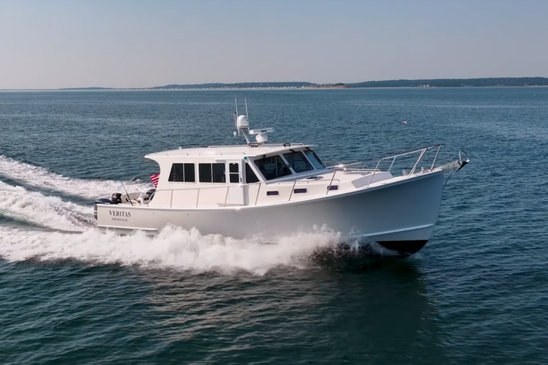Starboard bow view of a 2016 Wesmac 42 cruising, with ocean and sky visible.