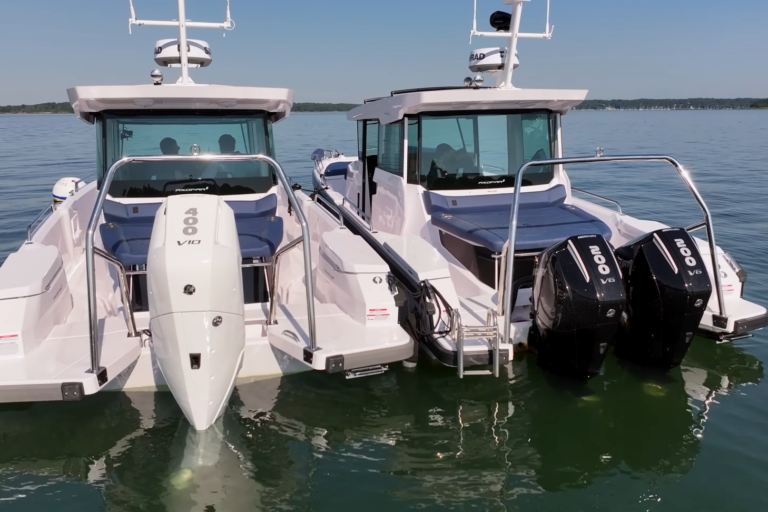 Stern view of two Axopar 29s floating, with a white single V10 400hp engine boat on the left and a black twin V6 200hp engine boat on the right.