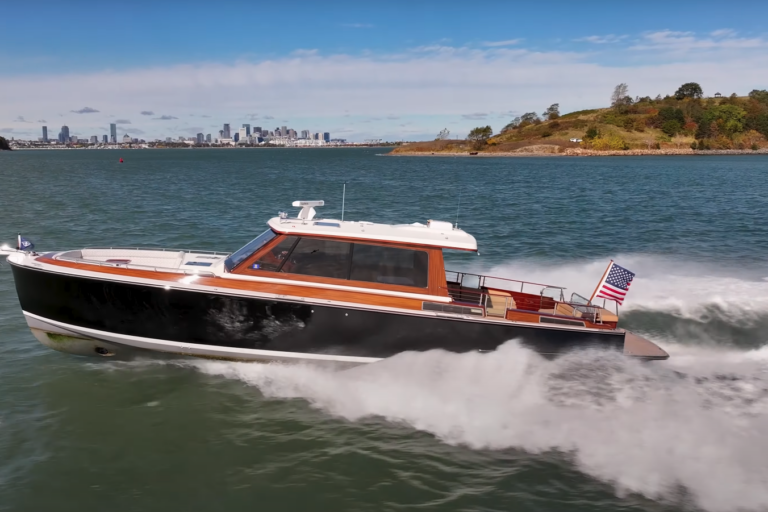 Boston Boat Works 48’ Daychaser cruising at speed with the Boston skyline visible in the distance.