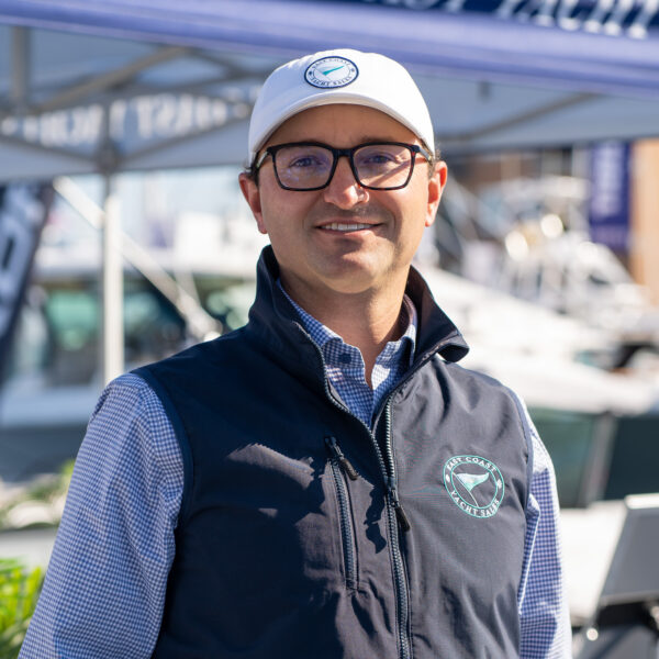 Headshot of Ben Knowles, President and Owner of East Coast Yacht Sales, taken at the Newport International Boat Show 2025 with the East Coast Yacht Sales tent in the background.