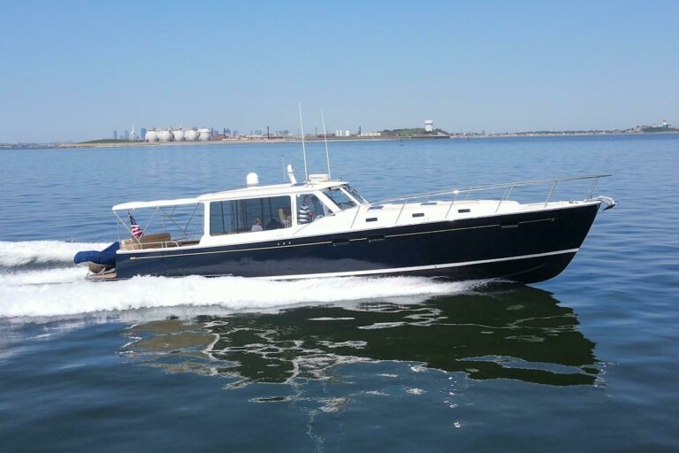 MJM 50z cruising on calm water with glass-like reflections.