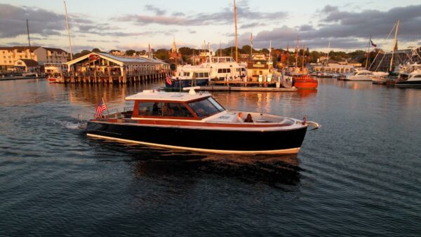 2024 Boston Boatworks 48’ Daychaser slowly cruising through a harbor at golden hour.