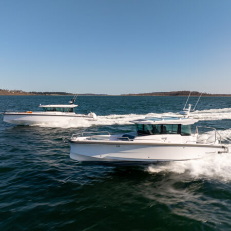 Axopar 29 XC Cross Cabin and Axopar 37 XC Cross Cabin BRABUS edition cruising side by side in Casco Bay, Maine.