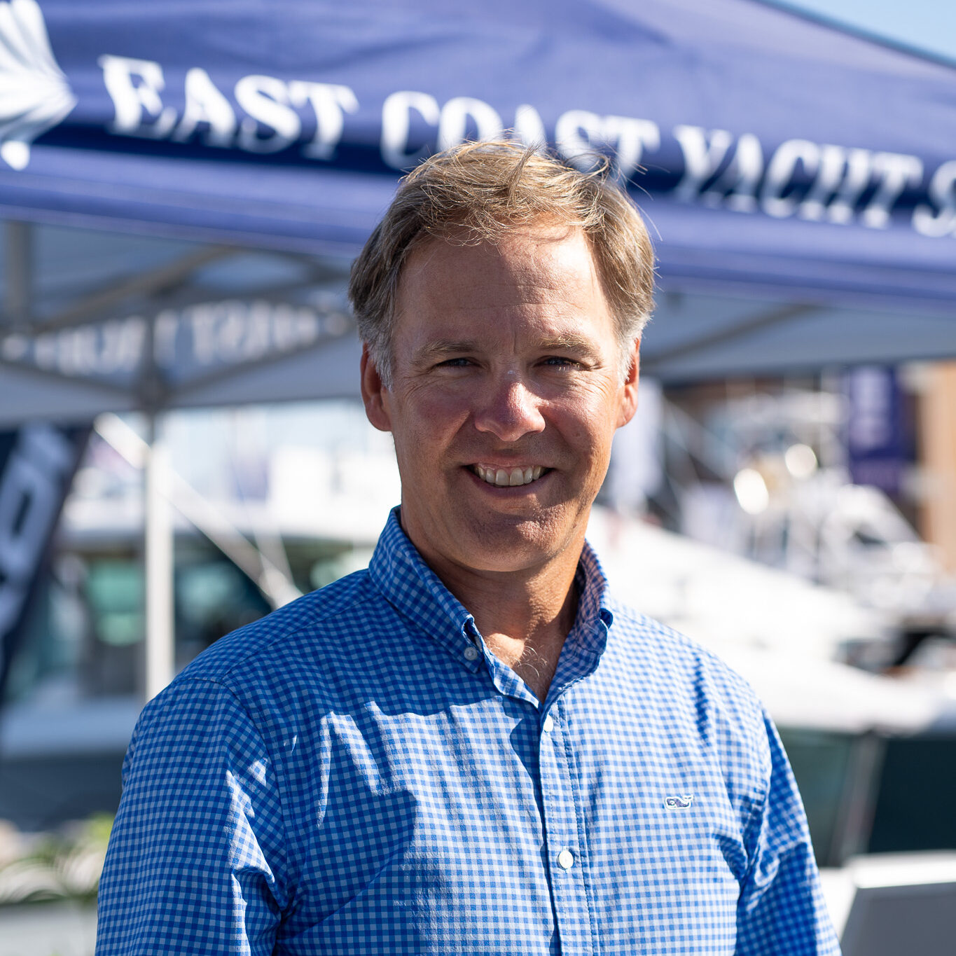 Andrew Porter – Yacht Consultant, East Coast Yacht Sales, Portsmouth, RI Headshot of Andrew Porter, Yacht Consultant based in Portsmouth, Rhode Island, taken at the Newport International Boat Show 2025 with the East Coast Yacht Sales tent in the background.