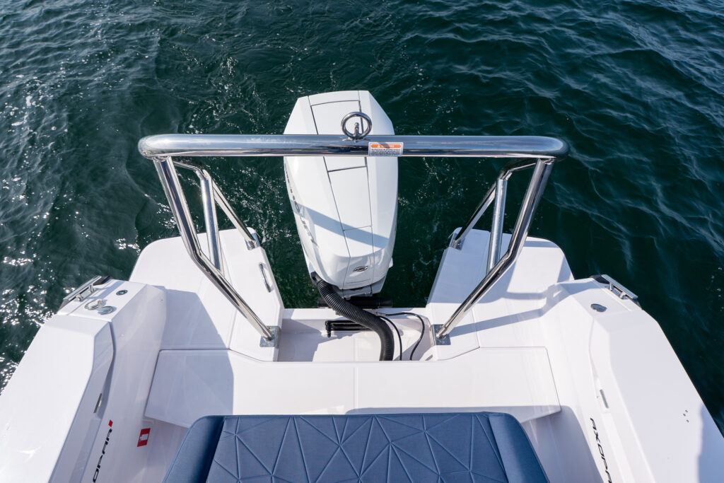 Aft swim platform of an Axopar 29 featuring a stainless-steel ski tow bar positioned above a single Mercury V10 Verado outboard engine.