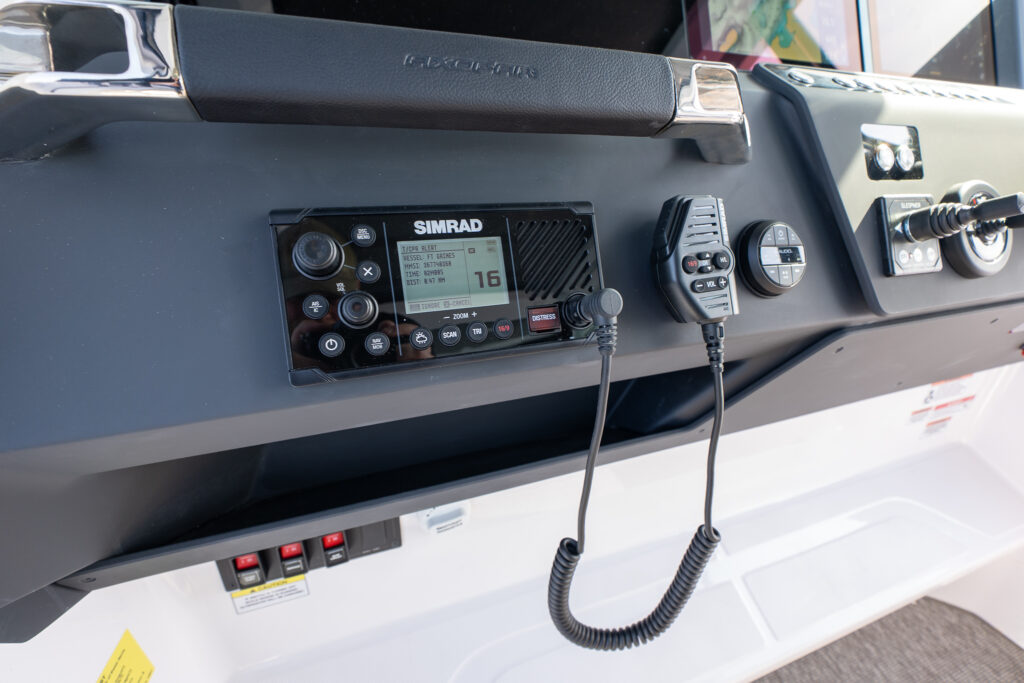Close-up of Axopar 29 Stock 34 SIMRAD short-range radio with branded handle across the top