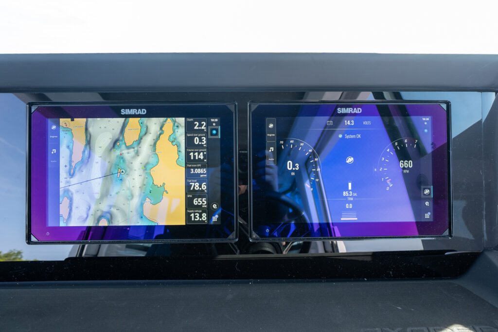 Close-up of Axopar 29 Stock 34 dual Simrad MFDs showing chart plotter and system information including speed, RPM, trim, and fuel