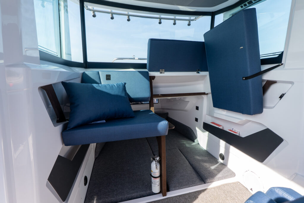 View from inside the Axopar 29 XC Stock 34 looking aft toward the aft cabin entrance and rear seats with blue Sphere upholstery