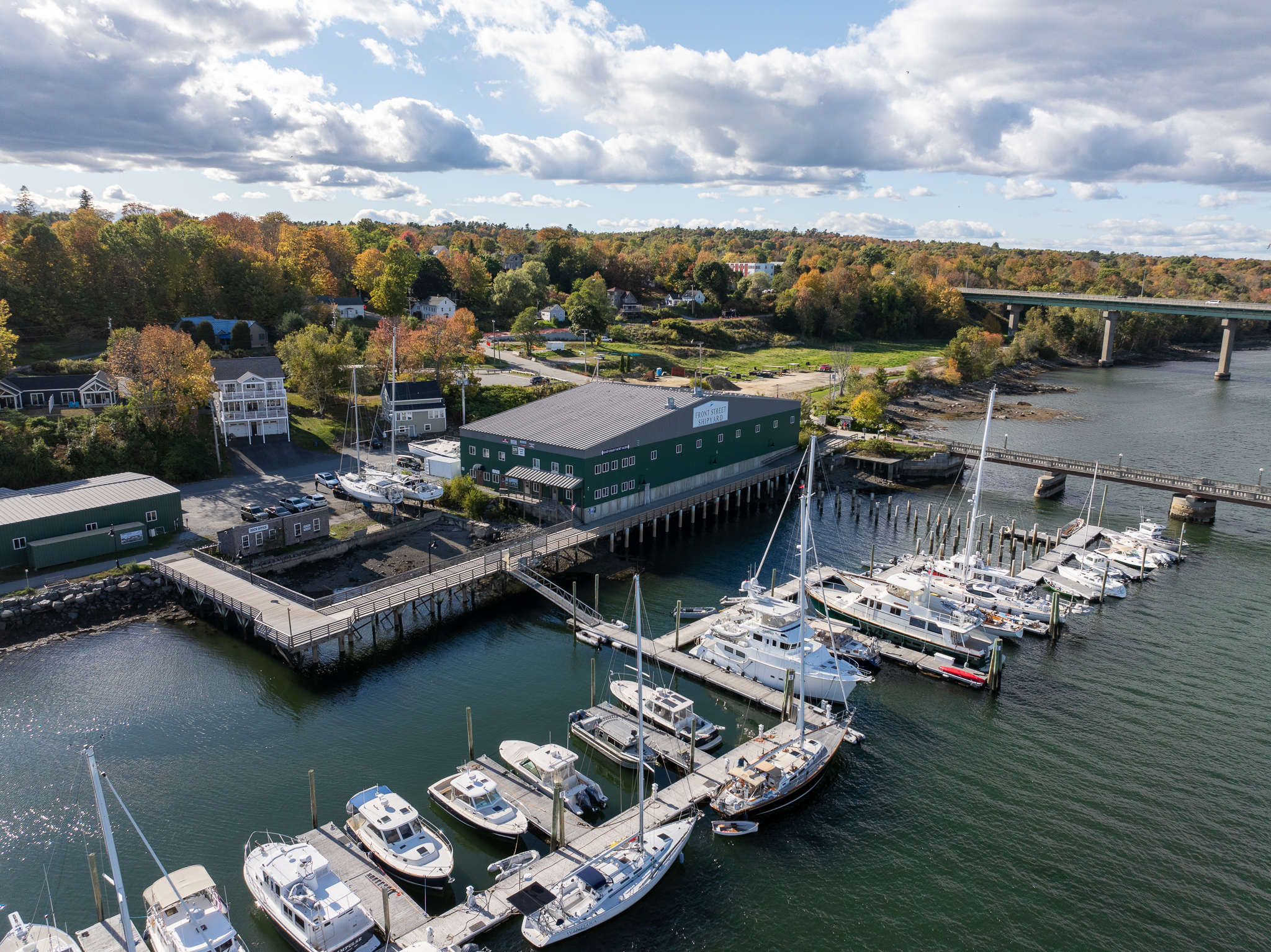 Aerial view of East Coast Yacht Sales’ Belfast, Maine office with boats docked along the waterfront