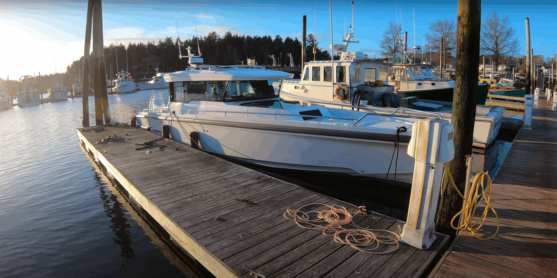 Axopar 37 docked in Northeast Harbor, Maine at sunrise on a calm March morning