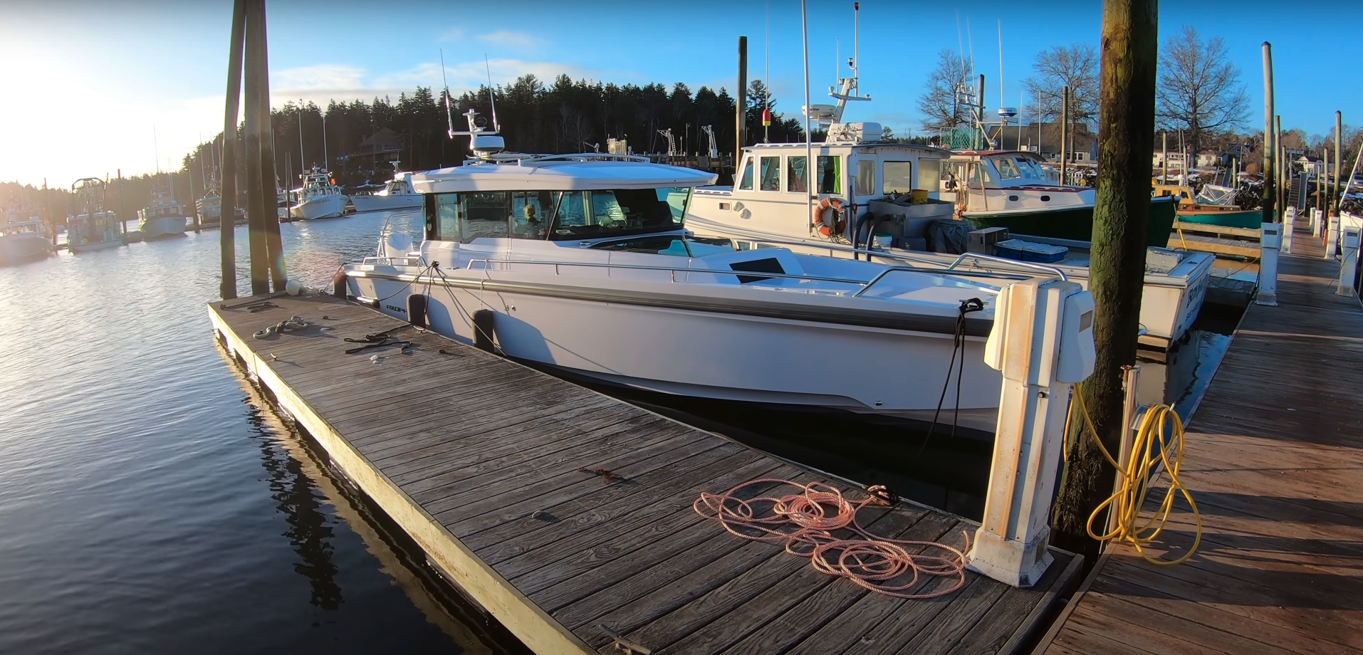 Axopar 37 docked in Northeast Harbor, Maine at sunrise on a calm March morning