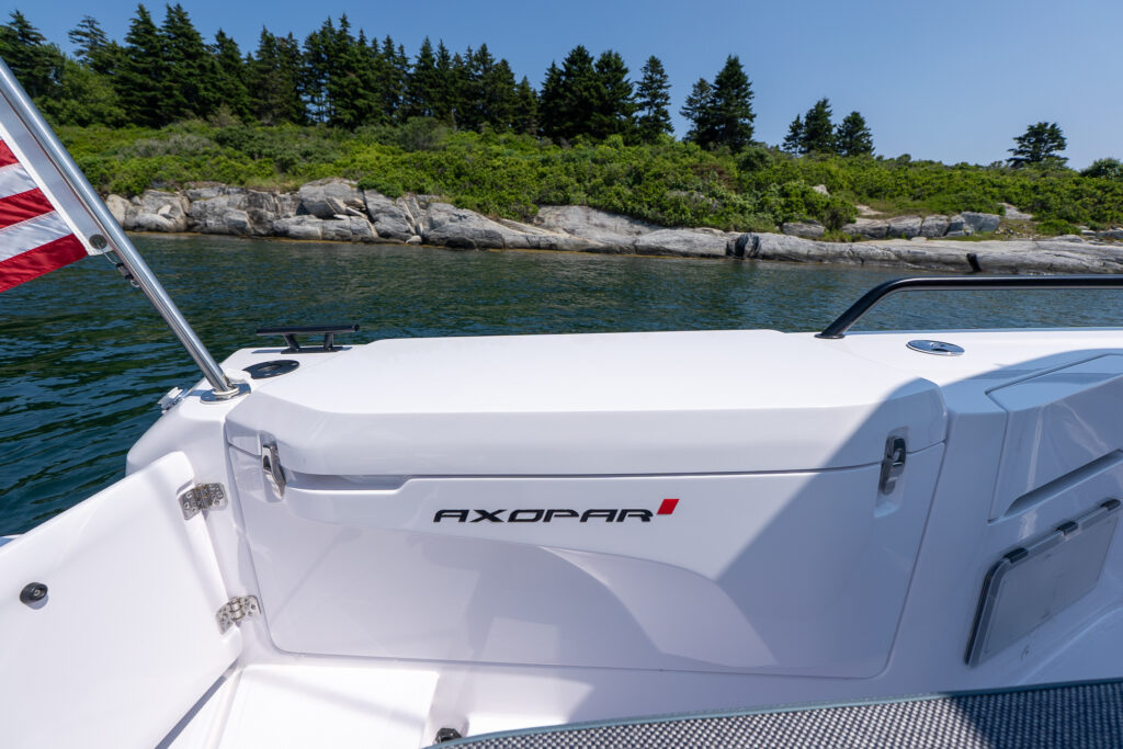 Close-up of the starboard aft fender box on an Axopar 37, showing the AXOPAR logo, integrated fender box, and surrounding deck area.