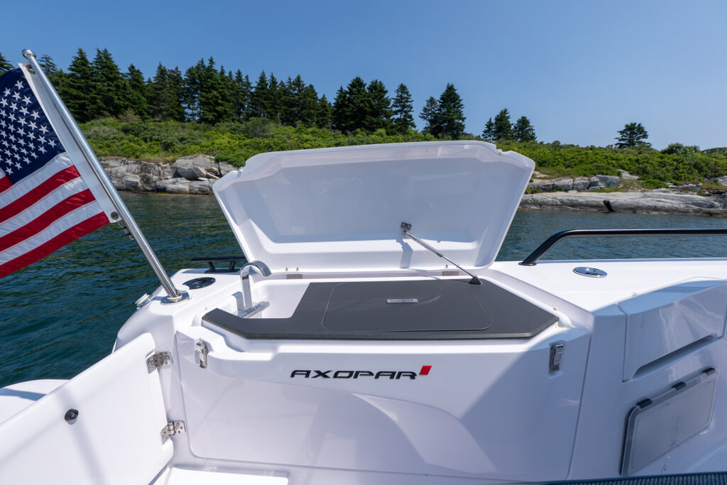 Open aft fender box hatch on an Axopar 37, revealing the integrated aft wet bar and sink area.