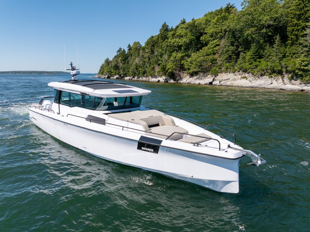 Axopar 45 BRABUS Performance Line cruising past a rocky, tree-lined shoreline in Casco Bay, Maine.