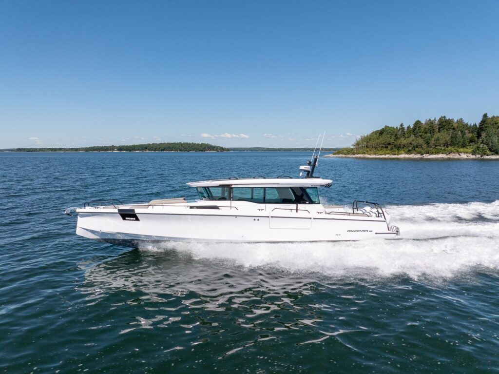 Side profile of an Axopar 45 BRABUS Performance Line cruising fast across Casco Bay, Maine, leaving a wide white wake.