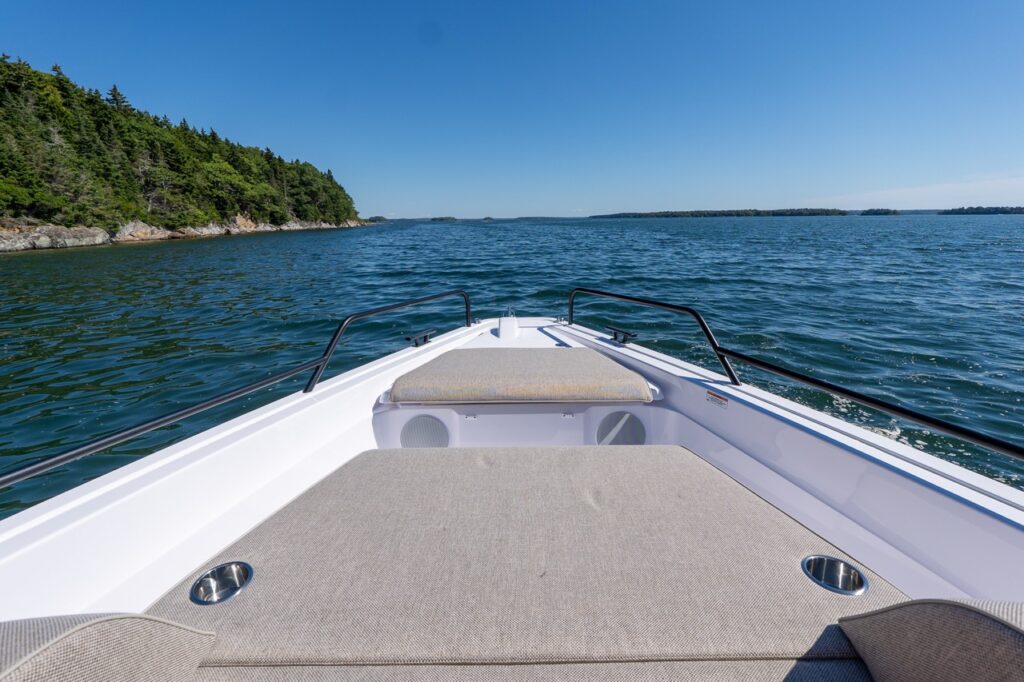 Forward view over the Axopar 45 BRABUS Performance Line foredeck sunpad and bow lounge in Casco Bay, Maine.