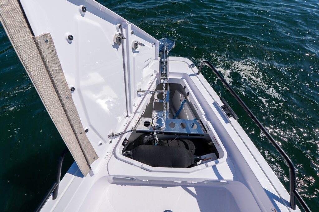 Open anchor locker on an Axopar 45 BRABUS Performance Line showing windlass, chain, and storage at the bow in Casco Bay, Maine.