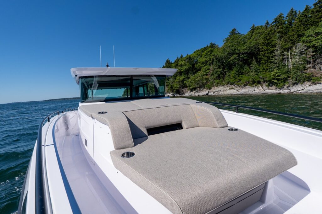 Close view of the Axopar 45 BRABUS Performance Line forward sun pad with wide walkaround side decks in Casco Bay, Maine.