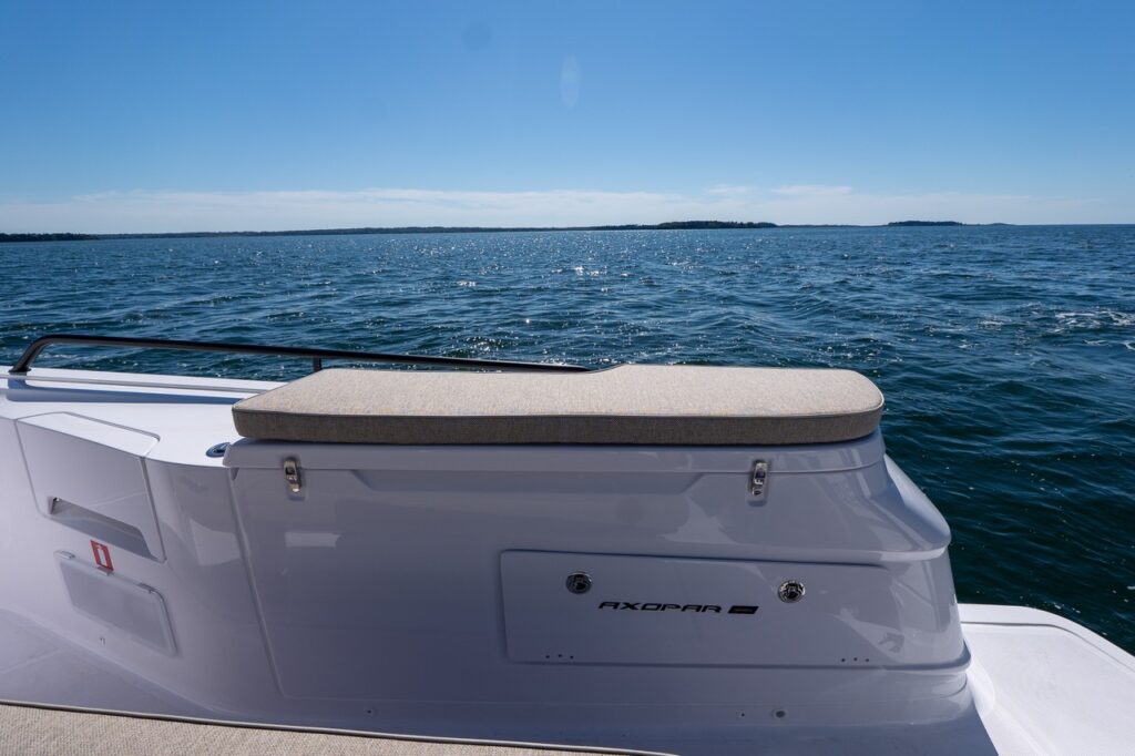 Starboard-side fender box with cushioned top on an Axopar 45, with open water in the background in Casco Bay, Maine.