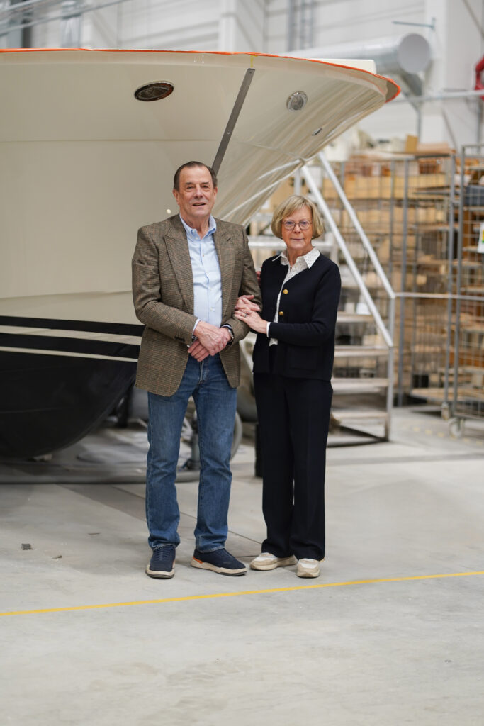Photo of Johan and Britt-Marie Carpelan in front of the bow of a Targa Boat in the factory