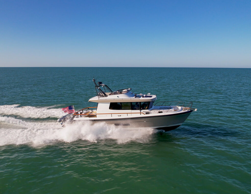 Targa 41 with Gray Hull Cruising through blue-green open ocean with a blue sky