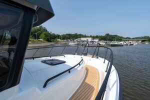 Starboard-side foredeck walkway on the Targa 32 with teak-style decking, high railings, and access toward the bow.