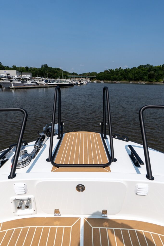 Bow area of the Targa 32 showing the integrated swim ladder and anchor windlass with teak-style decking.