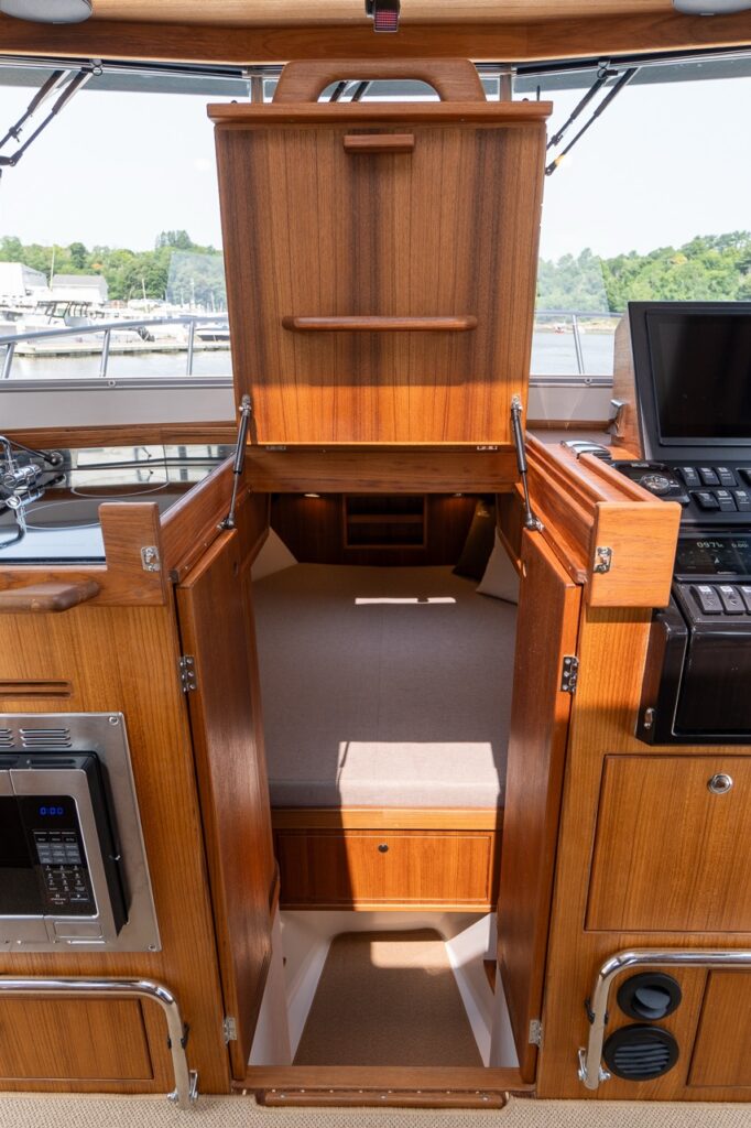 Entryway from the pilothouse down into the Comfort Forward Cabin on the Targa 32 with wood cabinetry and steps.