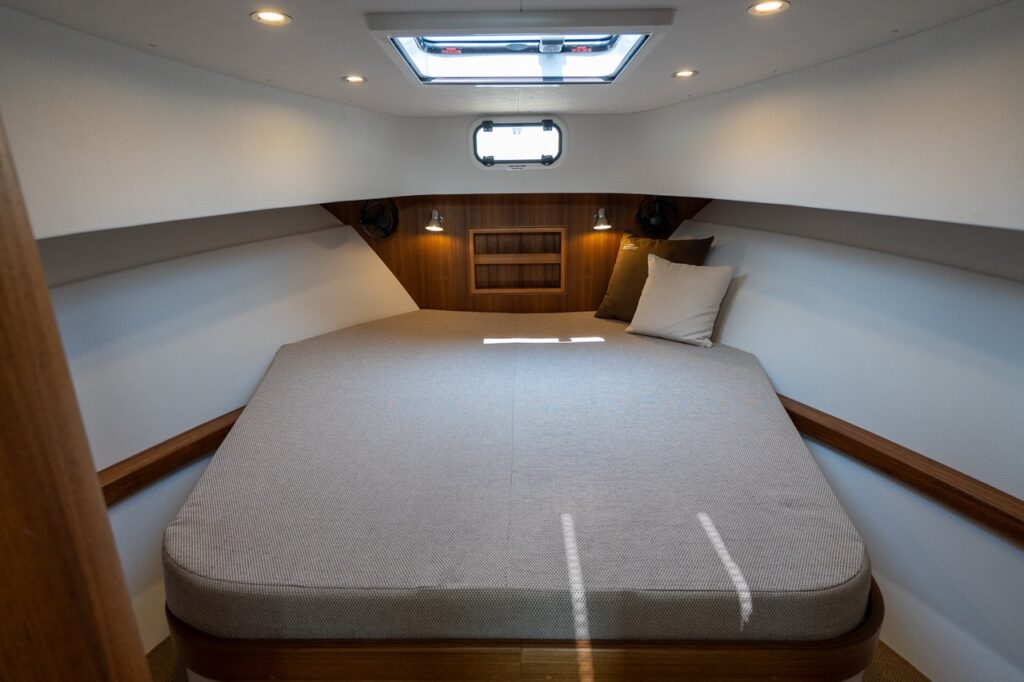 Large forward berth inside the Comfort Forward Cabin on the Targa 32 with overhead hatch and wood trim.