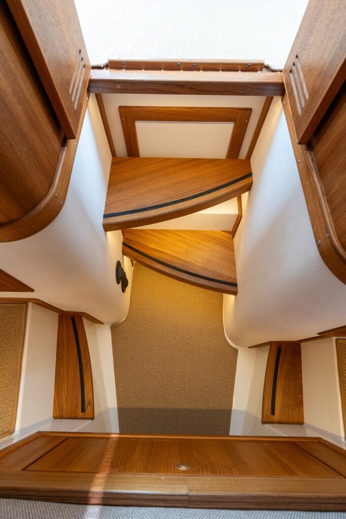 Wood-trimmed steps leading from the pilot house down into the Comfort Forward Cabin on the Targa 32.