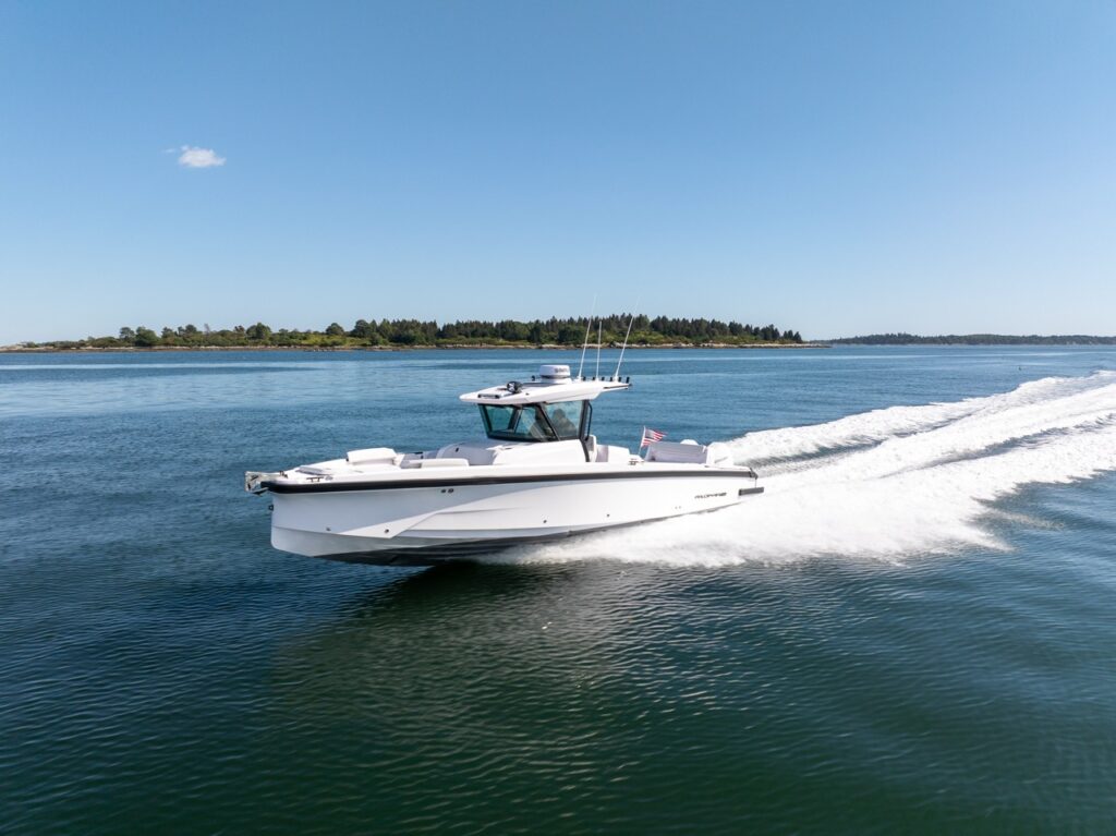 Axopar 29 CCX center console running at speed across calm water with a long white wake and a Cross Top overhead.