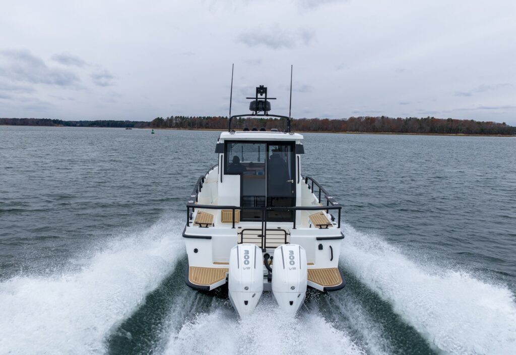 Stern view of a Targa 27.2 Coupe with twin outboard engines cruising in Casco Bay, Maine