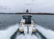 Stern view of a Targa 27.2 Coupe with twin outboard engines cruising in Casco Bay, Maine