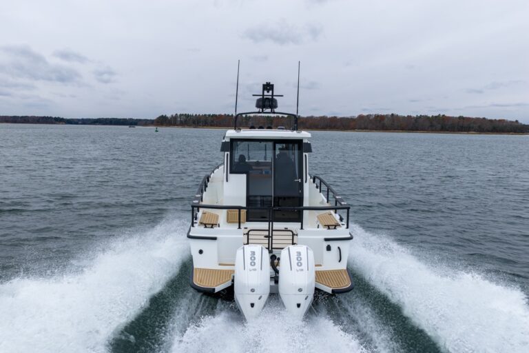 Stern view of a Targa 27.2 Coupe with twin outboard engines cruising in Casco Bay, Maine