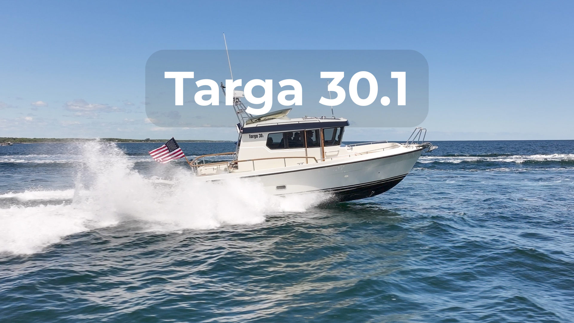 Targa 30.1 pilothouse boat underway in open water with American flag flying, showcasing all-weather design and offshore capability