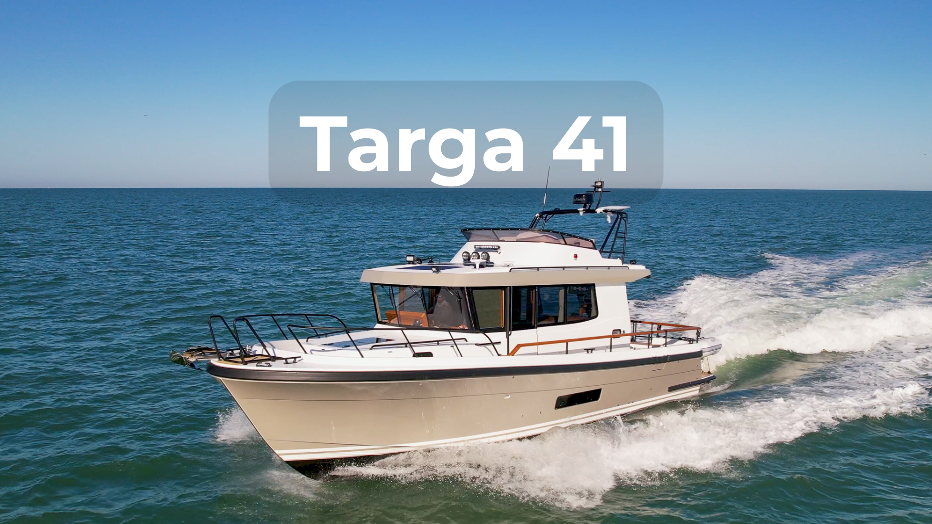 Targa 41 cruising offshore at speed, featuring an enclosed pilothouse, wide side decks, and a seaworthy hull design