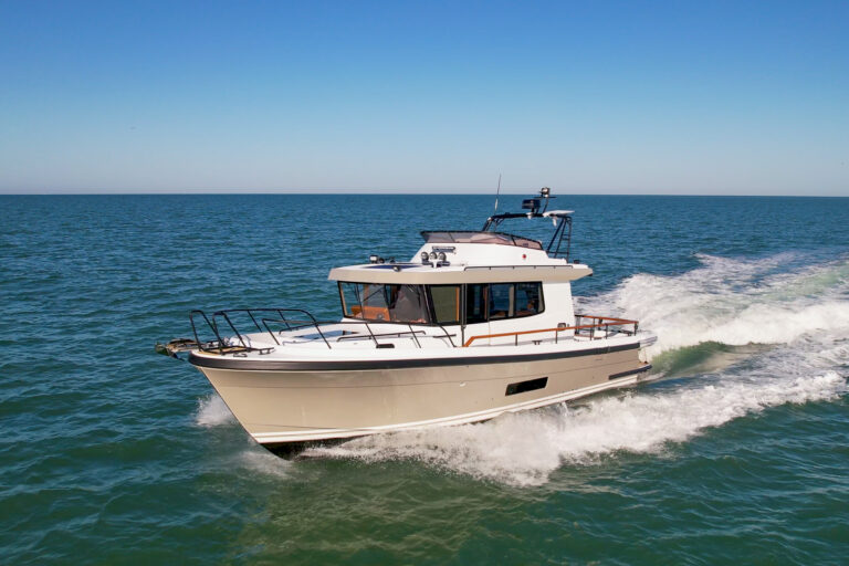 Targa 41 pilothouse cruiser running offshore in calm blue water, showcasing all-weather performance and protected walkaround decks