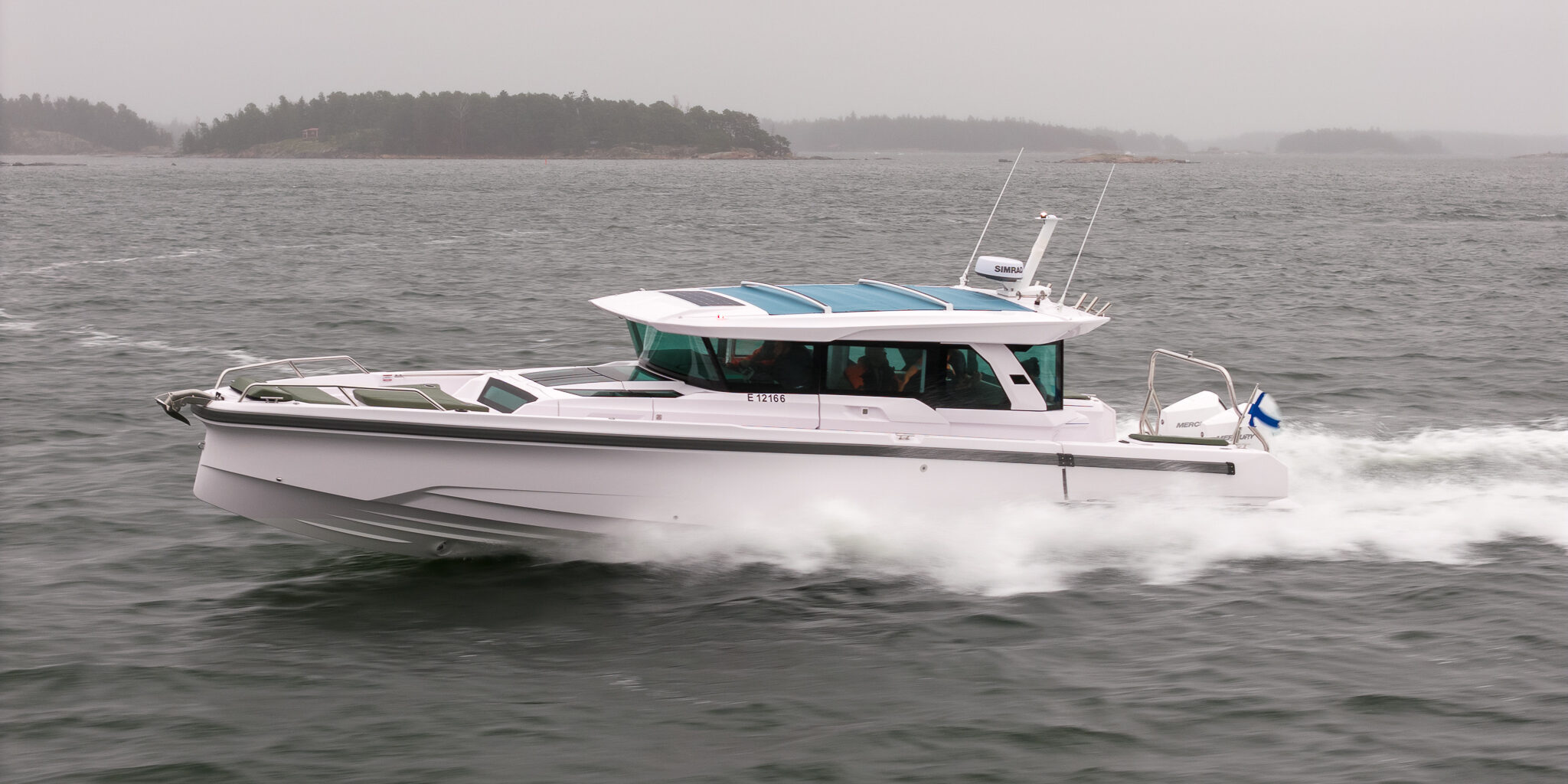 Axopar 38 running at speed in the Finnish archipelago off Helsinki during Axopar 38 media day, showcasing side profile and hull design in open water.