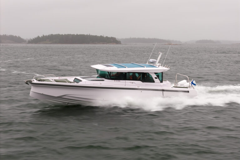 Axopar 38 running at speed in the Finnish archipelago off Helsinki during Axopar 38 media day, showcasing side profile and hull design in open water.