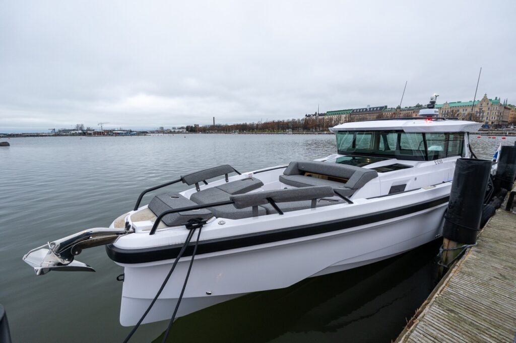 Angled view of the Axopar 38 forward seating area, looking aft toward the pilothouse while docked.