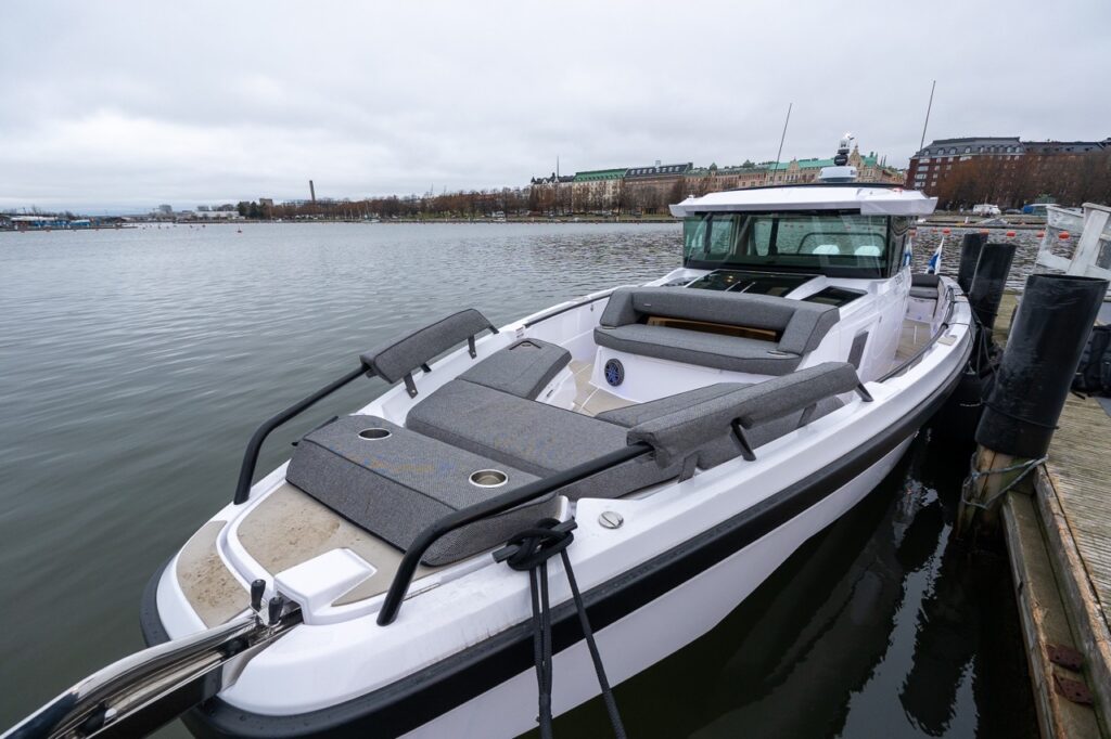 Full view of the forward seating area on the Axopar 38, looking aft toward the forward cabin roof and pilothouse.
