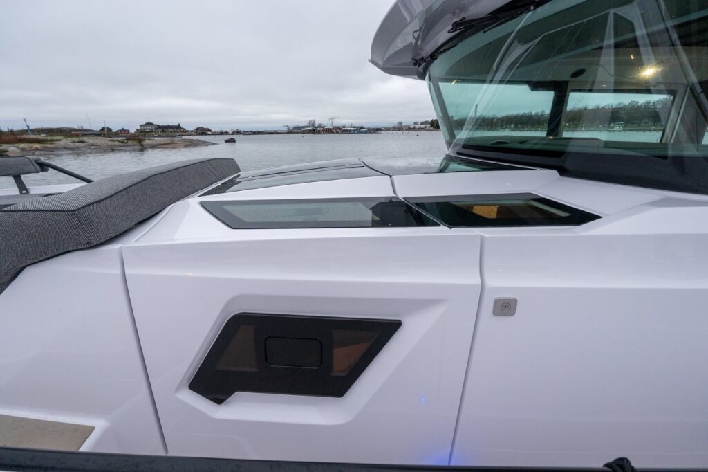 Athwartship view of the Axopar 38 showing the Power Dome skylights and Gullwing doors between the cockpit and pilothouse.