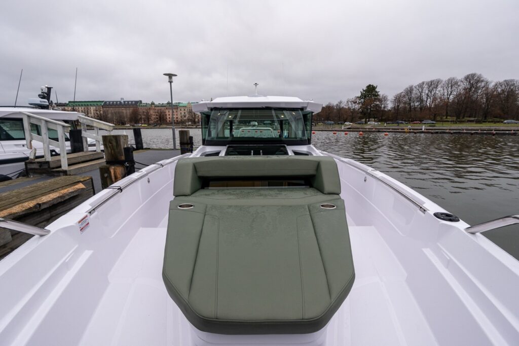 Axopar 38 forward sunbed with hunter green upholstery looking aft toward the pilot house during Axopar 38 media day in Finland.