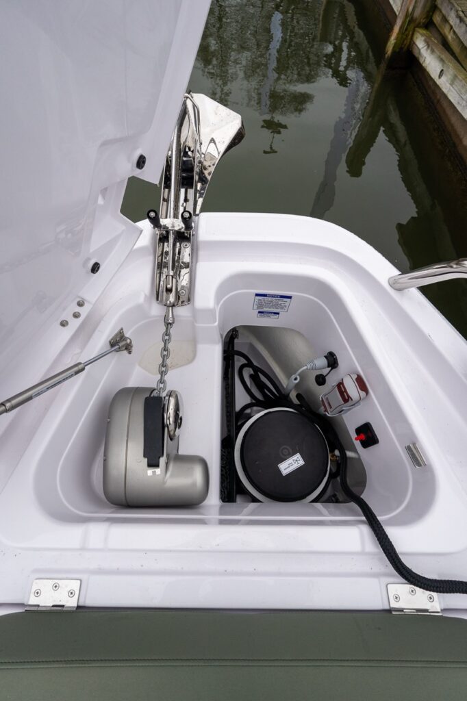 Axopar 38 anchor locker showing integrated windlass, anchor chain, freshwater washdown, and dedicated storage inside the bow locker.