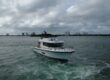 Targa 41 cruising in Florida waters from a forward port angle, showing the enclosed pilothouse, flybridge, and bow underway.