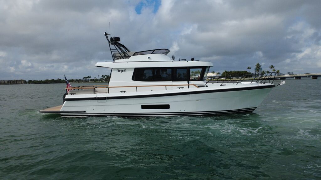 Starboard-side profile of a Targa 41 cruising in Florida waters, showing the enclosed pilothouse, flybridge, walkaround decks, and aft cockpit.