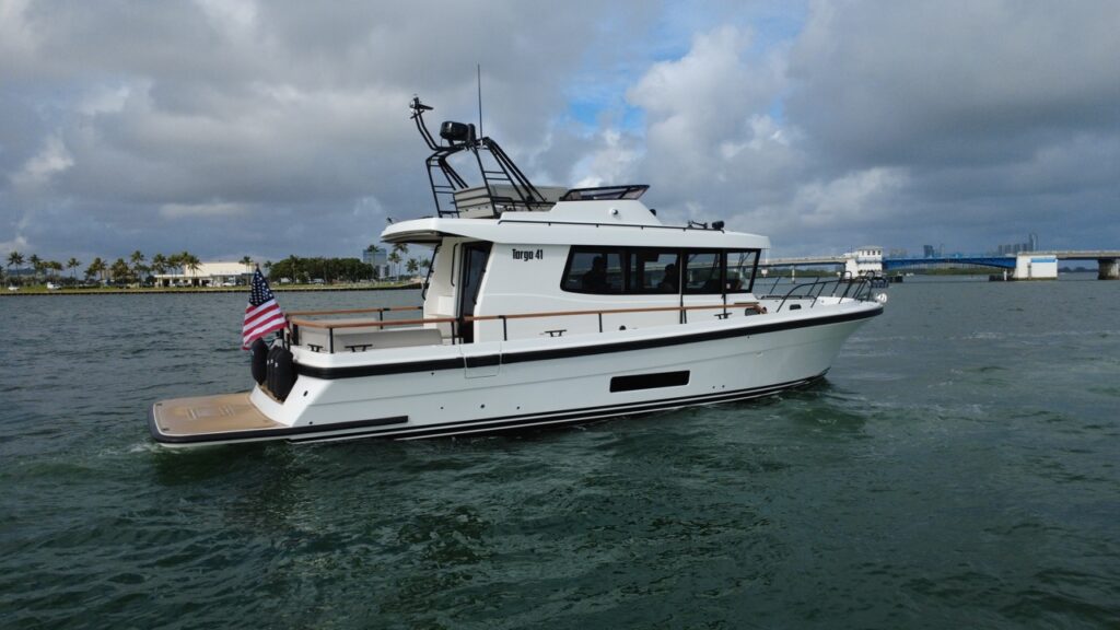 Starboard-side view of a Targa 41 underway in Florida, showing the enclosed pilothouse, walkaround decks, aft cockpit, and flybridge.