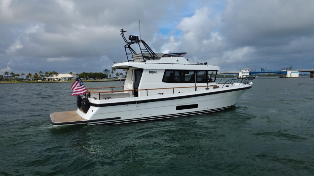 Starboard-side view of a Targa 41 underway in Florida, showing the enclosed pilothouse, walkaround decks, and flybridge.