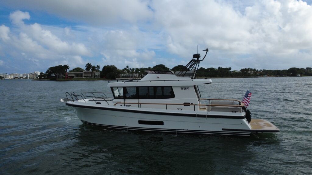 Side profile of a Targa 41 cruising in Florida, showing the pilothouse, flybridge structure, walkaround decks, and extended swim platform.